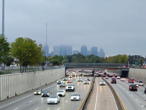 Traffic On Highway And Downtown Houston Skyline Surrounded By Clouds