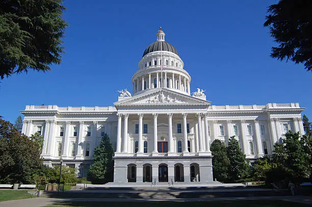 "The California State Capitol Building in Sacramento, flag flying at half mast."