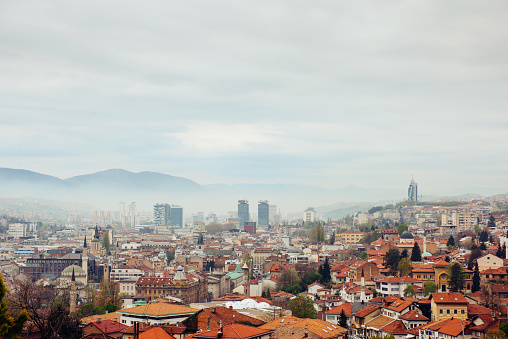 Panoramic view of the spring city of Sarajevo, Bosnia and Herzegovina. A trip to a European Balcan city in the mountains with orange roofs.