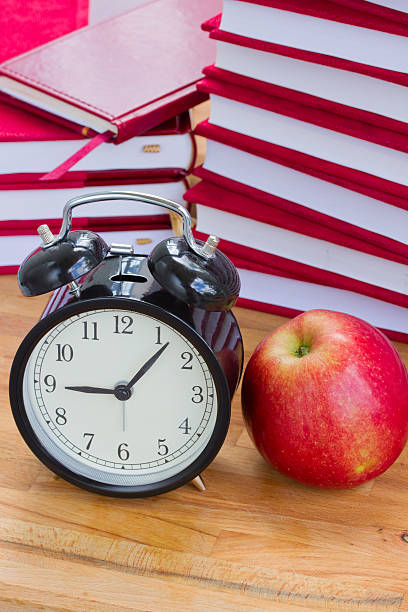 istock alarm clock and books on a table 179064948