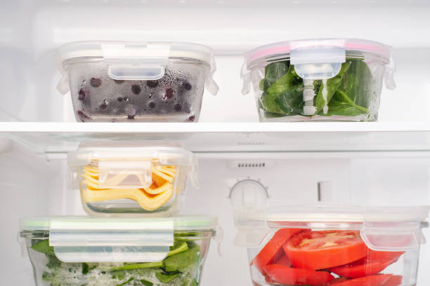 istock Vegetables and berries in glass boxes in the refrigerator close-up. 1790655755