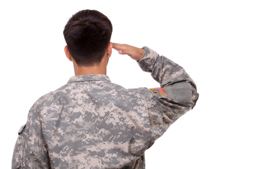 Rear view of an American soldier saluting