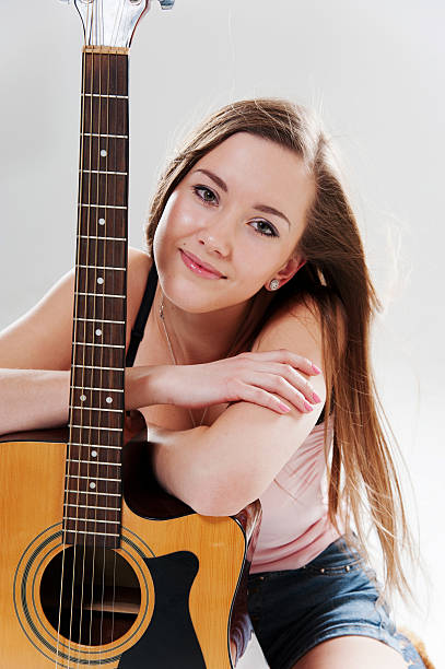 istock Smiling woman with guitar 179065705