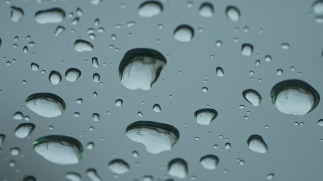Super slow video: Macro video of water droplets on the windshield