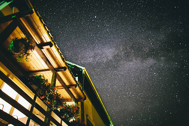 milky way over the rooftop of a house stock photo