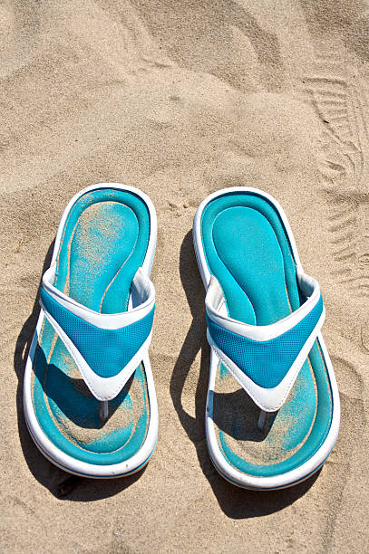 Flip flops in the sand stock photo