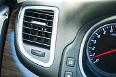 Interior of a modern car with air conditioner and speedometer