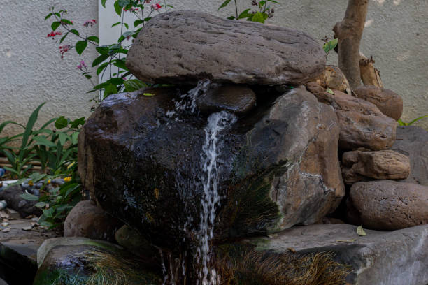 istock Fountain on the rocks above the fish pond 1790667819