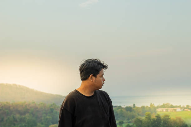 istock Man looking next to him on a mountain 1790670392