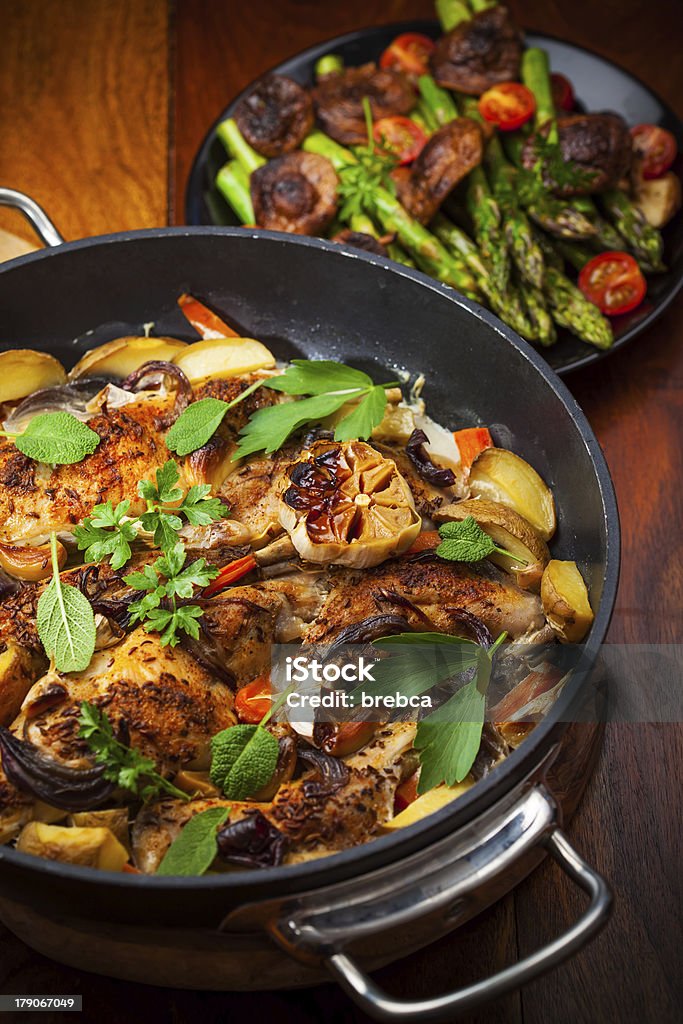 Roasted rabbit on vegetables Roasted rabbit on vegetables in pan Barbecue - Meal Stock Photo