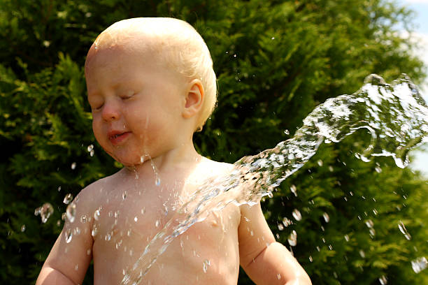istock Baby Spraying Himself in Face 179067421