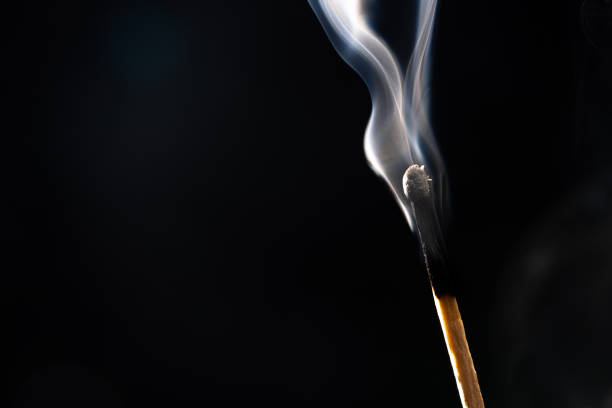 Close-up of one extinguished match in a group of green matches. The concept of burnout, stress, work-life balance, free space for text.
