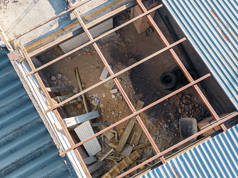 An aerial view of a ruined roof of a construction on a sunny day