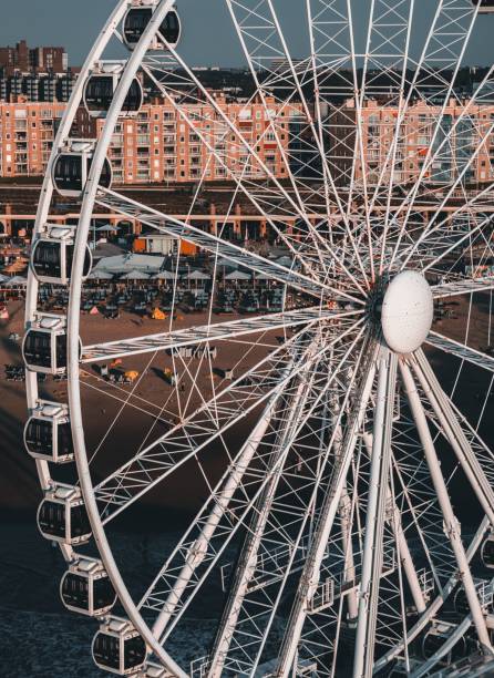 istock Ferris wheel stands tall against a pastel-colored sky in a beachfront location 1790687158
