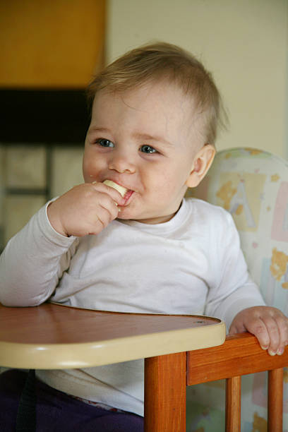 istock baby boy eating a banana 179069431