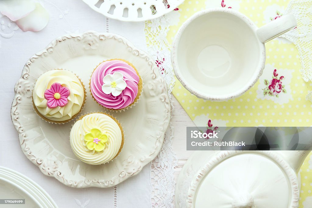 Afternoon tea and cupcakes served on a table Tea and cupcakes, overhead view Afternoon Tea Stock Photo