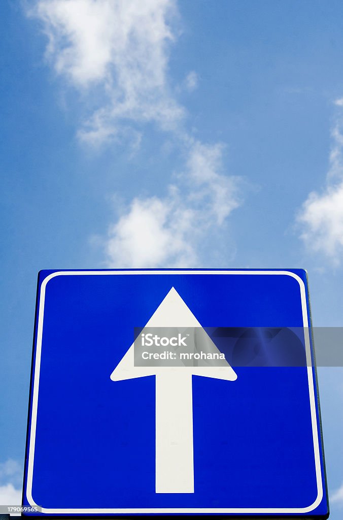 Straight to heaven Road signboard with white arrow over blue sky The Next Step Stock Photo