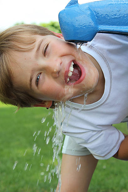 istock Happy young boy drinking water from a street tap 179070058