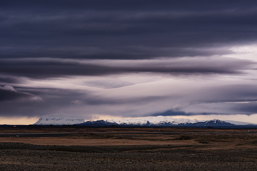 Moody clouds over snowcapped mountain in Iceland. Photographed in medium format.