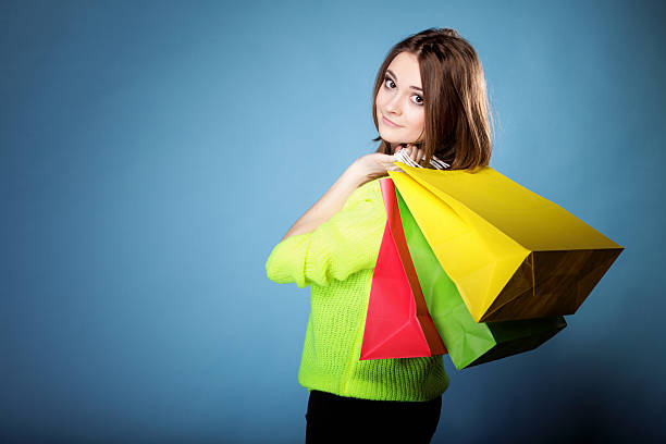 istock young woman with paper multi coloured shopping bag 179071312