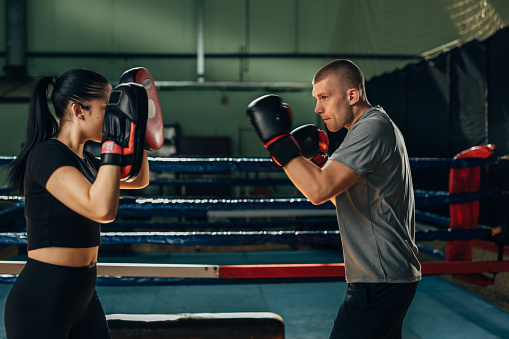 A man and a woman are practicing boxing