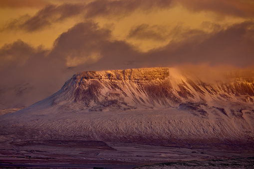 View of the snowcapped mountain during winter golden hour in Iceland.