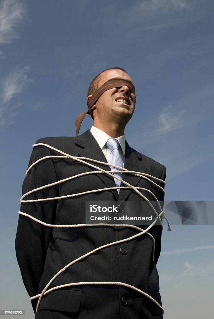 Stressed out Man tied up with blind fold on Adult Stock Photo