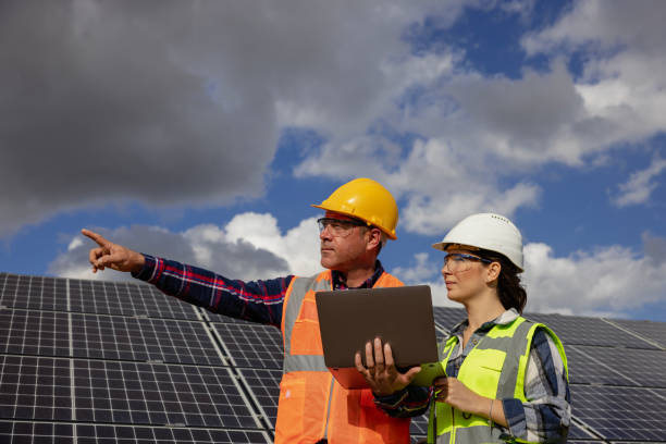 istock Two power engineers communicate and discuss at solar power plant 1790719881