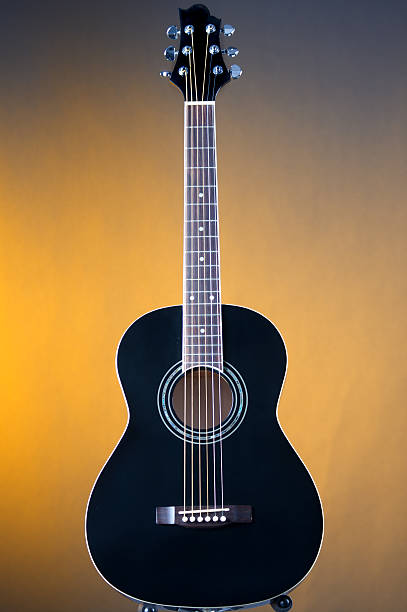 istock Black Acoustic Guitar On Yellow 179072521