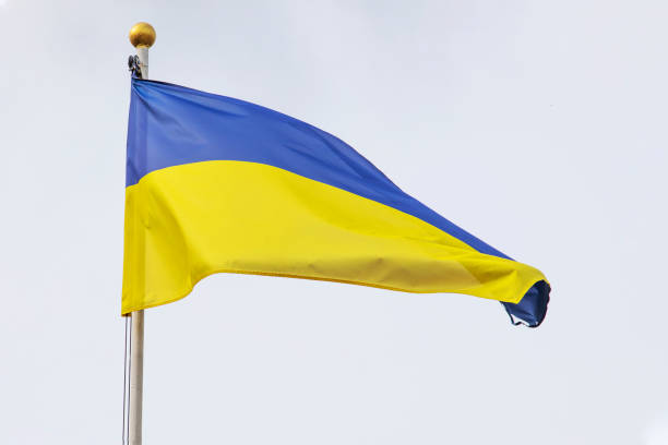 istock Ukrainian flag on a flagpole against a cloudy sky, with a focus on support and the challenges of war in Ukraine. 1790727271