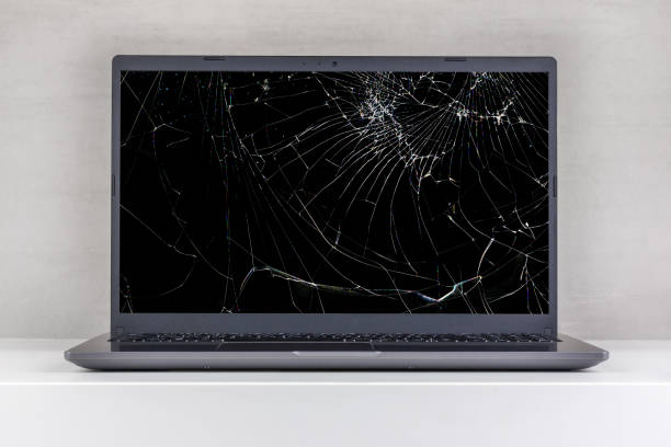 istock laptop pc with a broken screen in cracks on a gray background close up front view 1790727288