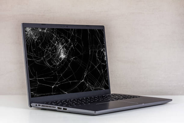 istock laptop pc with a broken screen in cracks on a gray background close up 1790727290