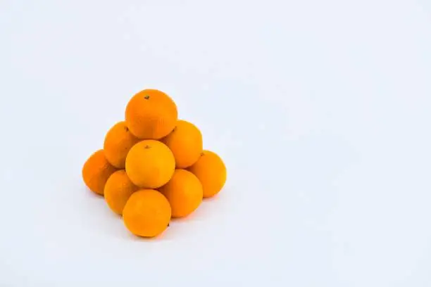 A delightful composition capturing the freshness of mandarins against a clean white backdrop.