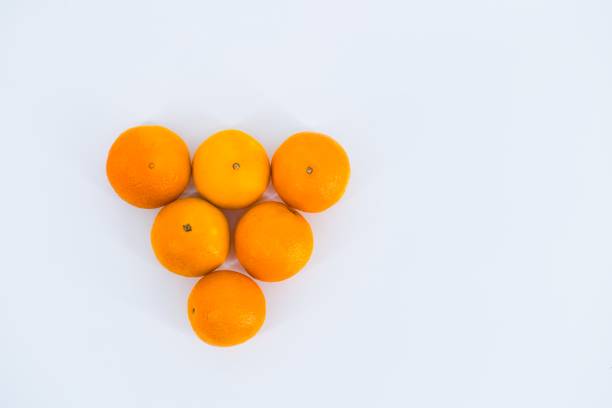 A delightful composition capturing the freshness of mandarins against a clean white backdrop.