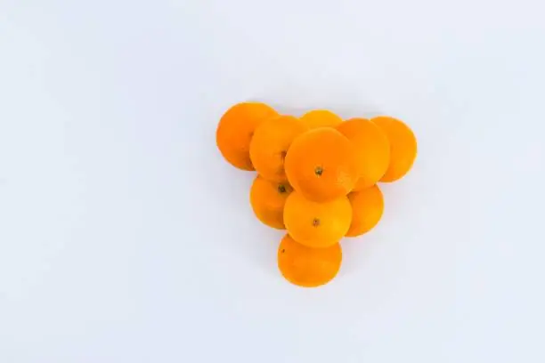 A delightful composition capturing the freshness of mandarins against a clean white backdrop.