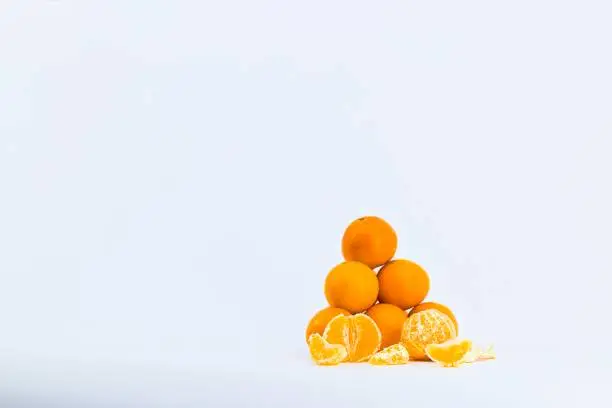 A delightful composition capturing the freshness of mandarins against a clean white backdrop.