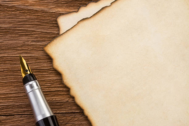 istock ink pen and parchment on wood 179072975