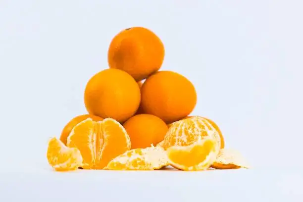 A delightful composition capturing the freshness of mandarins against a clean white backdrop.