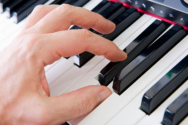Hands on piano stock photo