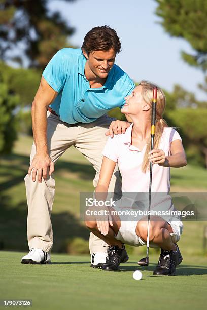 Couple Golfing On Golf Course Lining Up Stock Photo - Download Image Now - 20-29 Years, Adult, Celebration