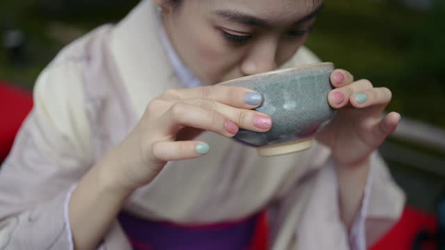 Beautiful asian women wear kimono enjoying japanese Matcha tea and dessert in japan