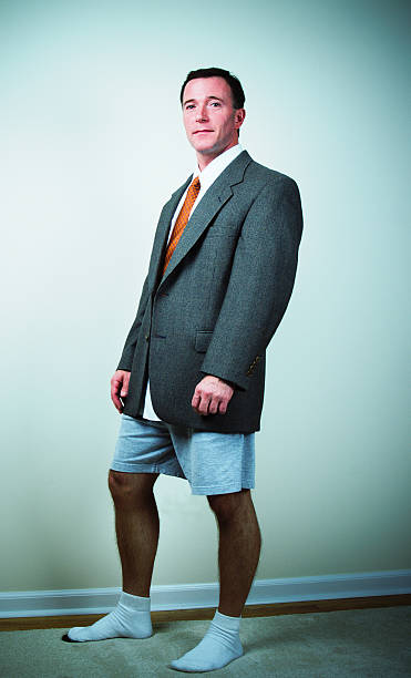 Men's Fashion Sport Coat, Boxer Shorts and Socks - XP "In a parody of men's fashion, a model stands half-dressed in a suit jacket and tie wearing shorts and socks. Digitally cross-processed." semi dress stock pictures, royalty-free photos & images