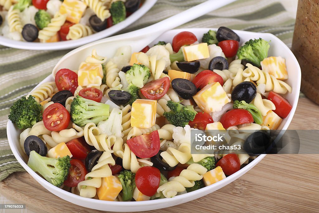 Pasta Salad Pasta salad with tomato, broccoli, black olives, cauliflower and cheese in a bowl Black Olive Stock Photo