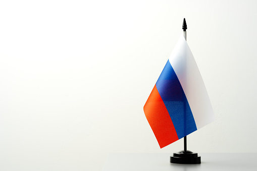 Small flag of Russia on flagpole close up photo