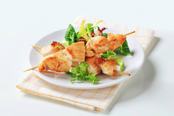 istock Chicken skewers and salad greens 179076564