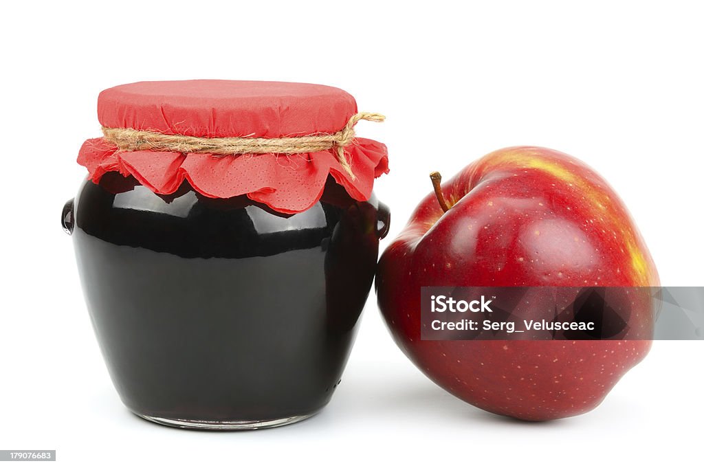 Red apple and pot of jam Red apple and pot of jam isolated on white background. Apple - Fruit Stock Photo