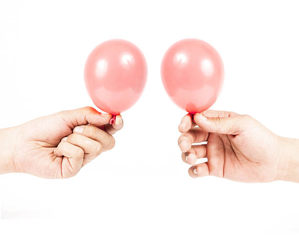 istock Hand holding colorful helium balloons 179077025