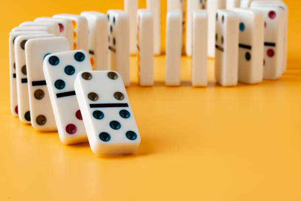 istock Row of domino tiles on yellow studio background 1790773594
