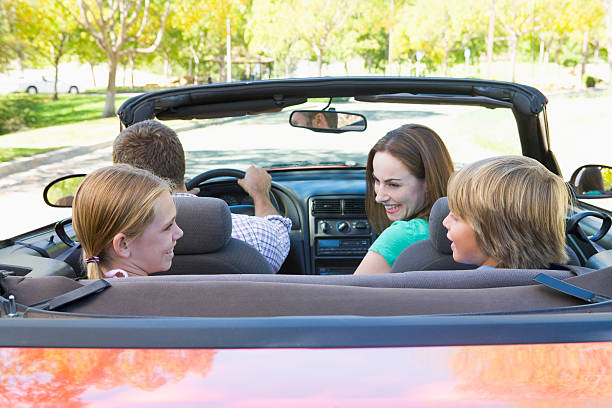 istock Family in convertible car smiling 179077442