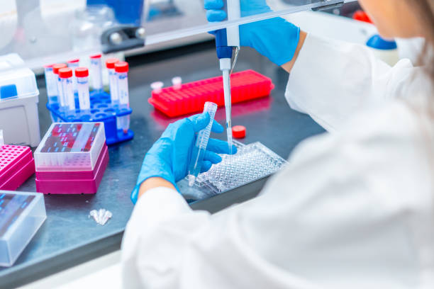 istock Doctor extracting samples from a tray in cancer research laboratory 1790780939